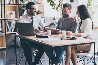 Financial adviser meeting clients sitting at a table