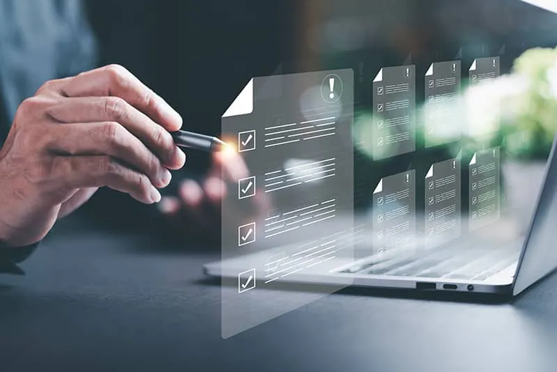 Person with pen and laptop and floating checklist